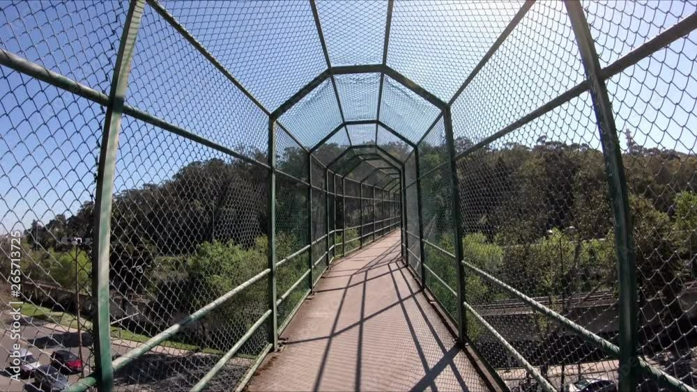 interior of a walkway bridge with protective metal mesh interior of a walkway bridge with protective metal mesh