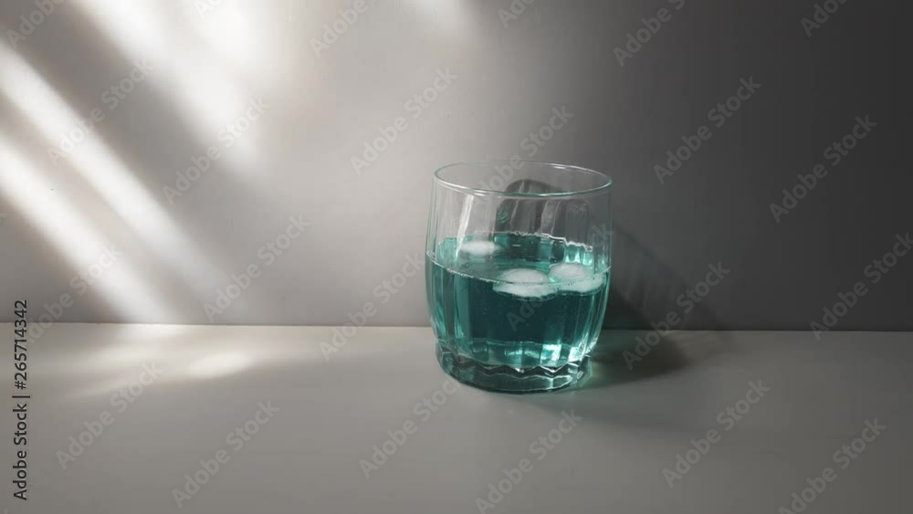Alcoholic drink of blue color in a glass glass. Drink with ice. Alcoholic drink of blue color in a glass glass. Drink with ice.