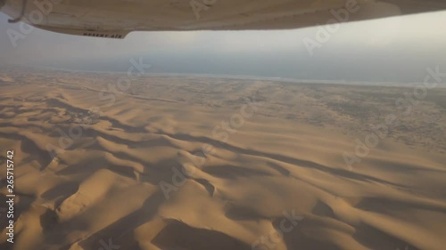 Wide Epic shot of the Skeleton Coast, Namibia, shot froma Small Airplane with Some Turbulence and Clouds photo