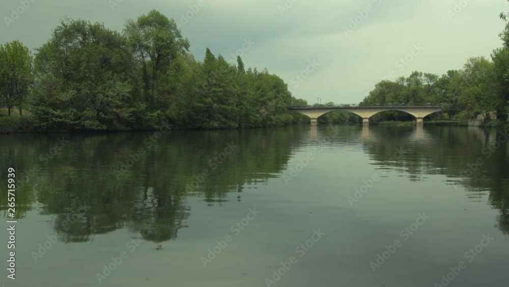 A slight overcast hangs over a calm river in Cognac, France. A slight overcast hangs over a calm river in Cognac, France.