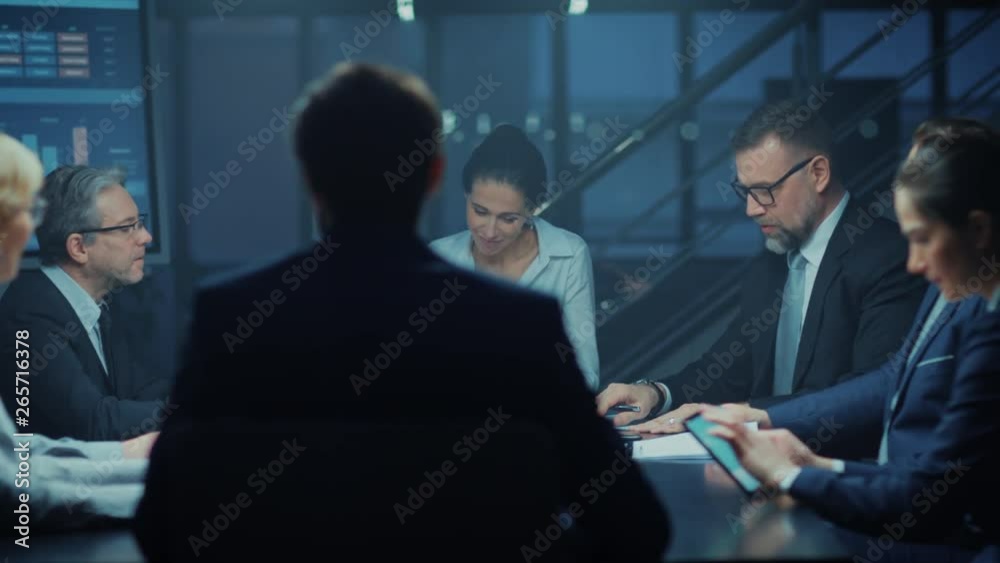 In the Corporate Meeting Room: Diverse Group of Business Associates and ExecutivesTalking, Negotiating, Debating, Working with Documents, Planning Strategy. Late at Night in the Office. High Angle In the Corporate Meeting Room: Diverse Group of Business Associates and ExecutivesTalking, Negotiating, Debating, Working with Documents, Planning Strategy. Late at Night in the Office. High Angle