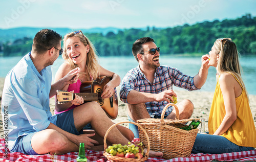 Group of friends having fun on the beach. Lifestyle, vacation concept © bobex73