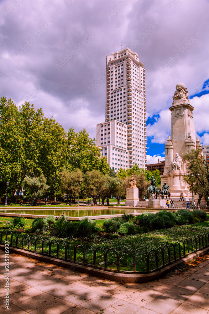 “Plaza de España” Madrid. View of the Cervantes monument and the Spain Building “Edificio Espana” on the Square of Spain “Plaza de Espana”. Madrid, Spain. Picture taken – 26 April 2019.