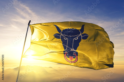 Quadro em tela Uri canton of Switzerland flag waving on the top sunrise mist fog
