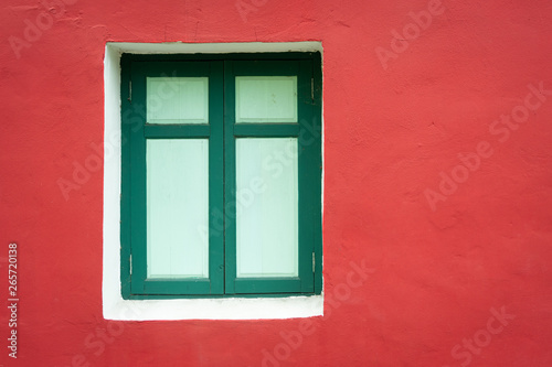 Green window frame with red cement wall vintage style.