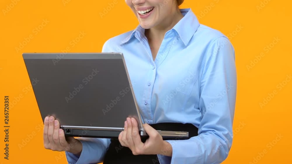 Excited business lady holding laptop and saying wow, shares climbed, market Excited business lady holding laptop and saying wow, shares climbed, market