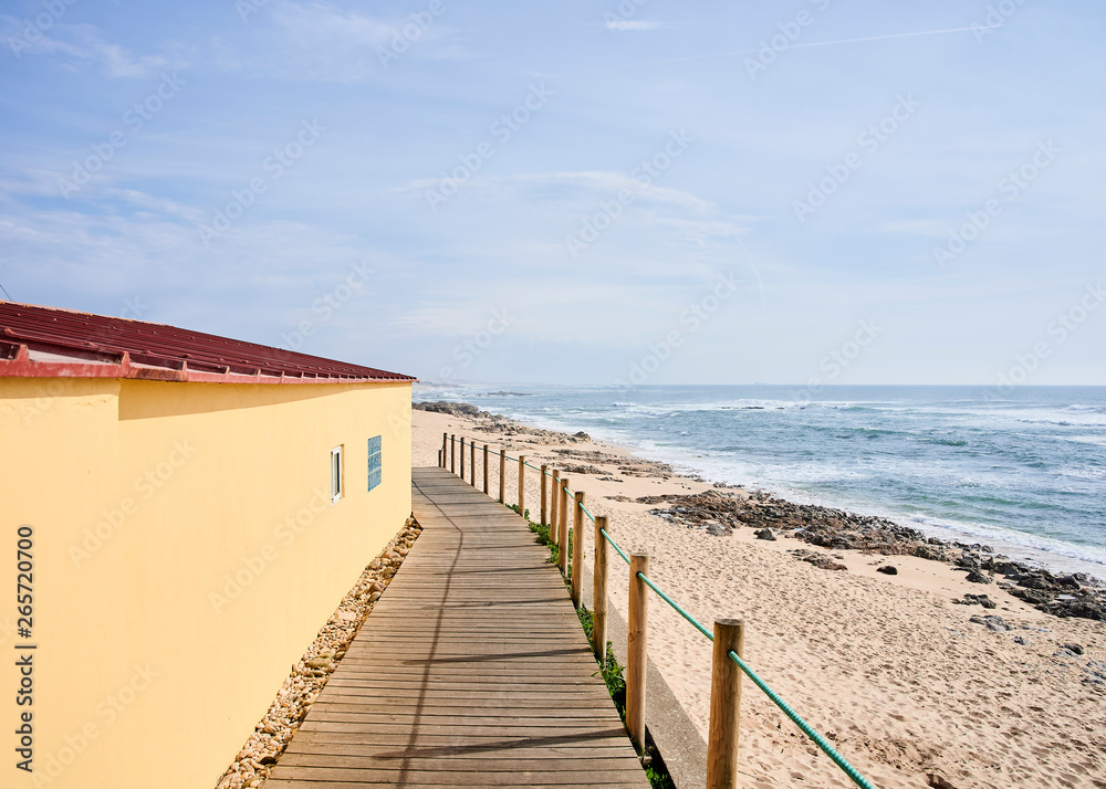 beach boardwalk between Arvore and Vila Chã passes close to a yellow fisherman house