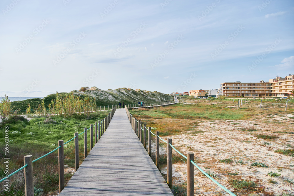 Wooden footwalk over the dunes in portugal near the beach