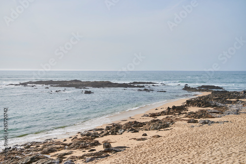 People on a empty beach on a winter day  view for far. Sand and sea at portugal