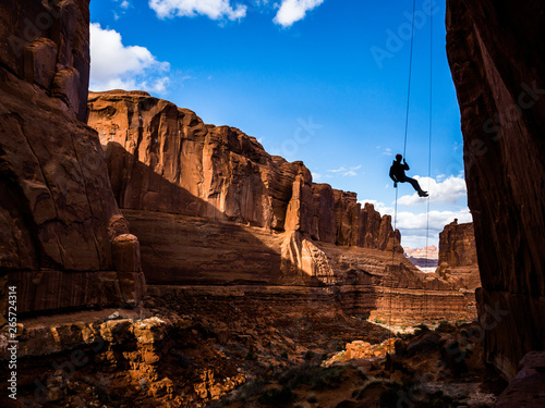 Free-hanging Rappel into Arches National Park canyon in Southern Utah desert. photo