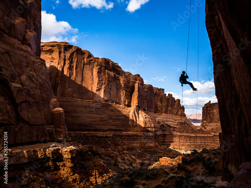 Photography Free-hanging Rappel into Arches National Park canyon in Southern Utah desert