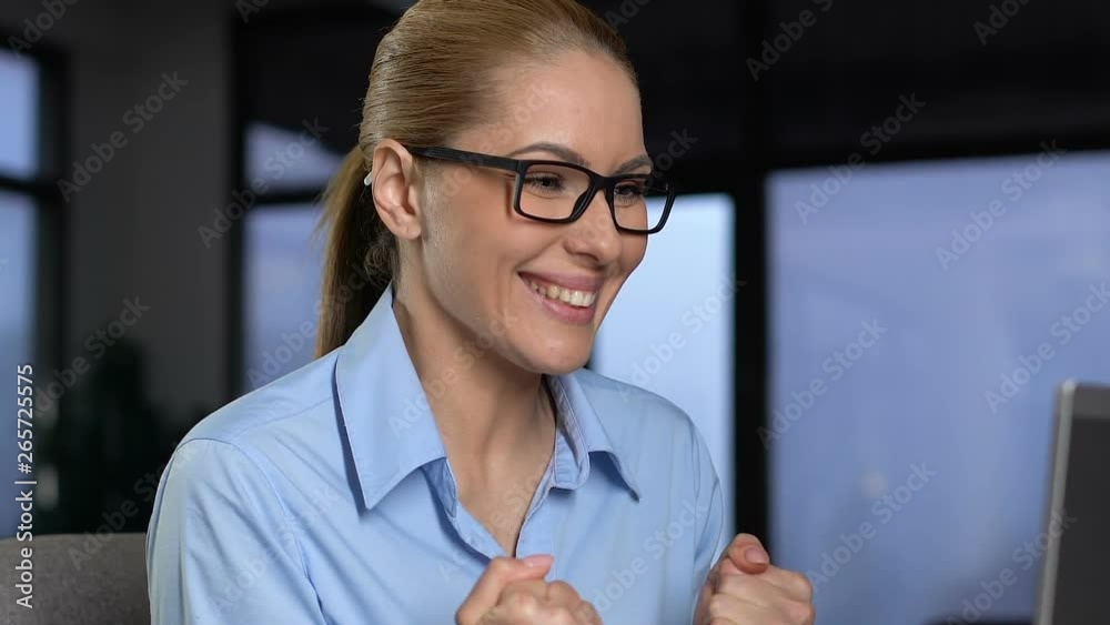 Excited business lady showing yes gesture reading email on laptop, success