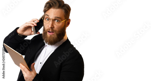 Smart business man in black suit and white shirt make a purchase online using tablet computer in glasses