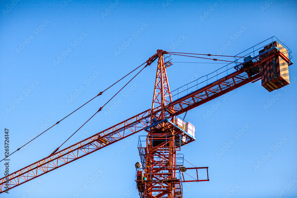 Construction crane tower on blue sky background. Construction crane tower on blue sky background.