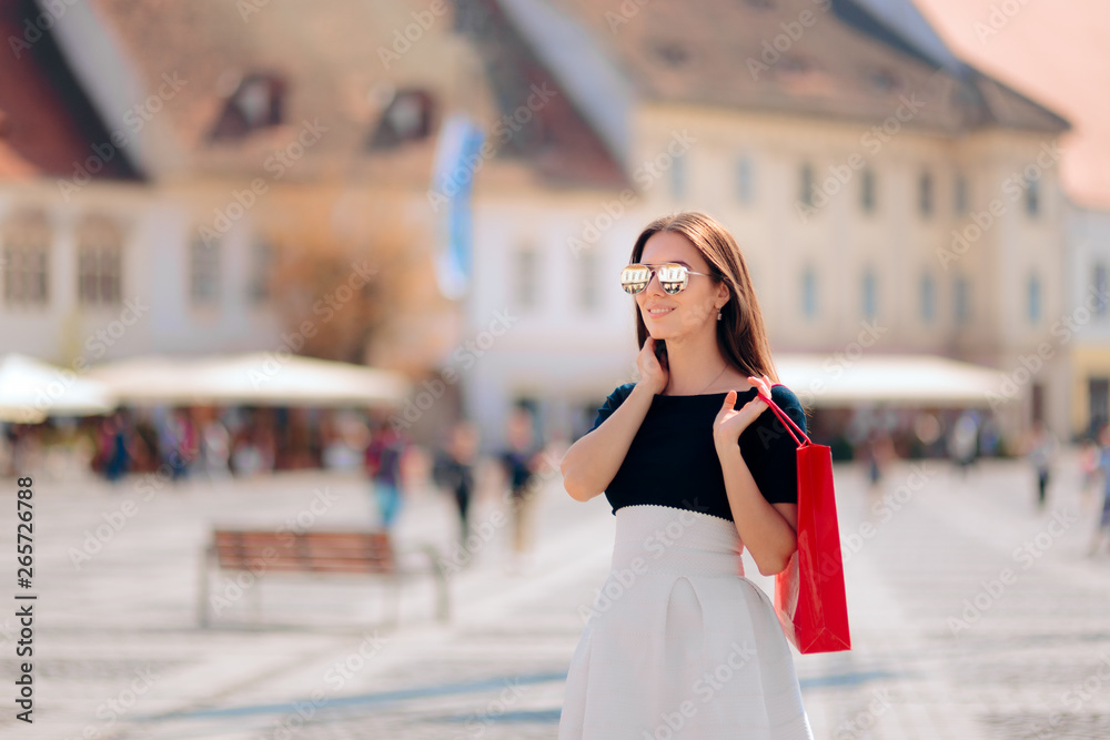 Fototapeta premium Tourist Woman with Shopping Bag Visiting Touristic Destination
