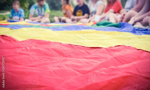 Colorful Parachute with Kids in Background in Gym Class Outdoor Activity