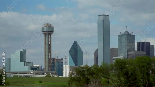 This is a time lapse of the Dallas, TX Skyline.  This is a Wider shot of the skyline. Clouds zoom by the beautiful Dallas Skyline on this sunny day. photo