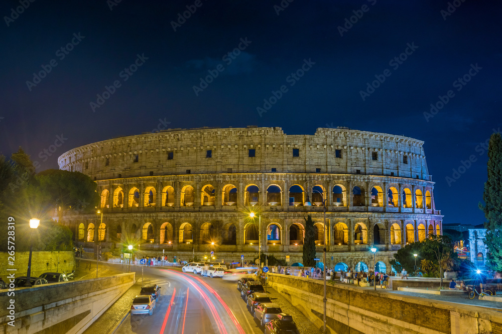 The Grand Colosseum the largest amphitheater built by the Roman Empire at night in Rome - Italy