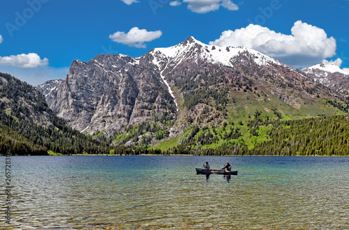 Canoers on a clear mountain lake