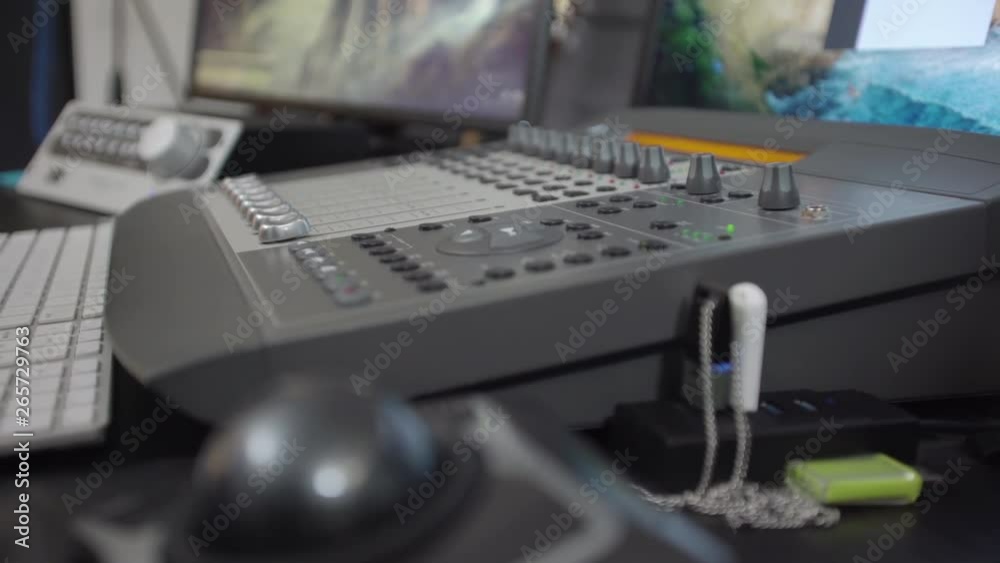 Dolly away from a sound mixing board revealing a ball mouse on the desk Dolly away from a sound mixing board revealing a ball mouse on the desk