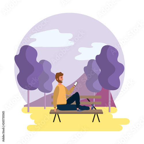 Millenial sitting on park bench outdoors