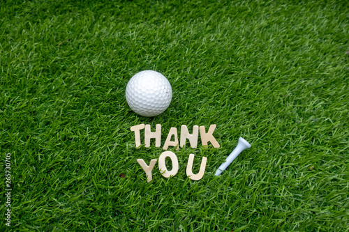 Golf thank you with golf ball and tee on green 