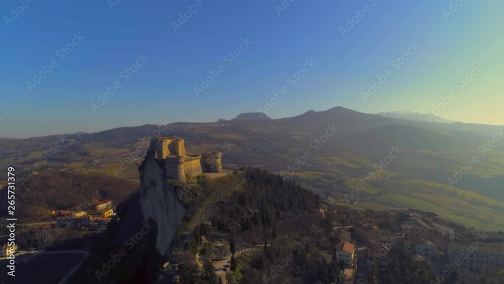 Beautiful aerial view of one of the most beautiful castles in Emilia Romagna, during a day with a clear blue sky and the bright sun, the fortress of San Leo Beautiful aerial view of one of the most beautiful castles in Emilia Romagna, during a day with a clear blue sky and the bright sun, the fortress of San Leo