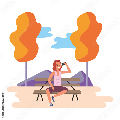 Millenial sitting on park bench outdoors