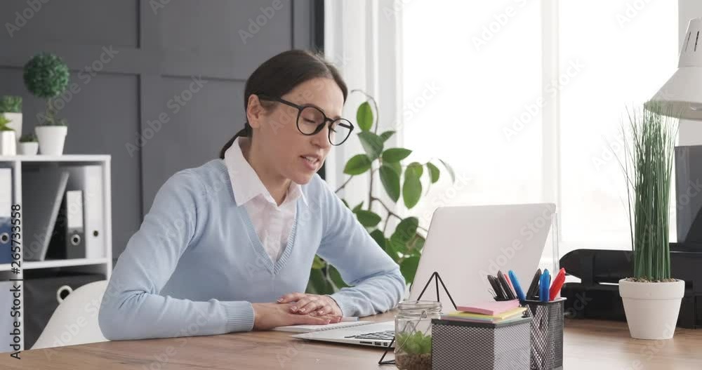 Businesswoman doing video call using laptop at office Businesswoman doing video call using laptop at office