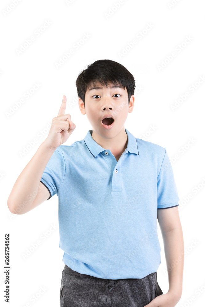 Young Asian boy thinking and pointing upwards while smiling . Young Asian boy thinking and pointing upwards while smiling .
