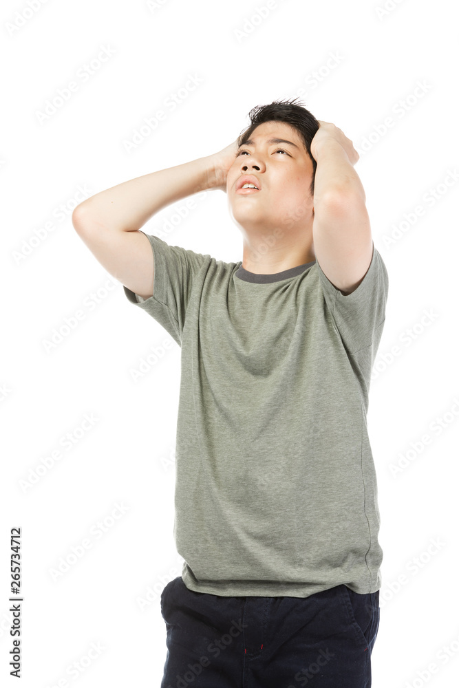 Young Asian boy over white background, be upset; have a bad temper emotional. Young Asian boy over white background, be upset; have a bad temper emotional.