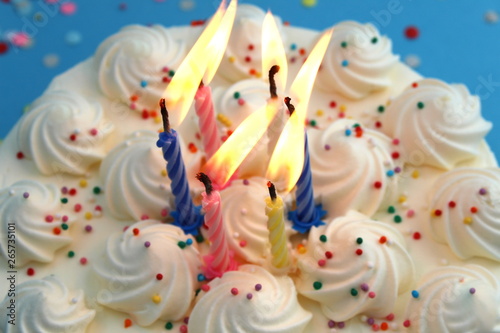Birthday cake with candles for birthday on a blue background with confetti