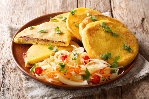 Tasty vegetarian pupusas recipe served with curtido closeup on a plate. horizontal photo