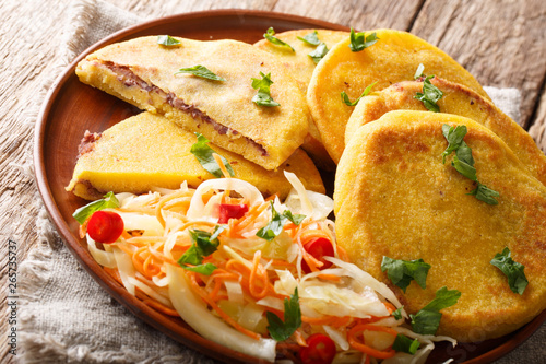 Salvadoran food fried Pupusas served with coleslaw close-up on a plate. horizontal photo