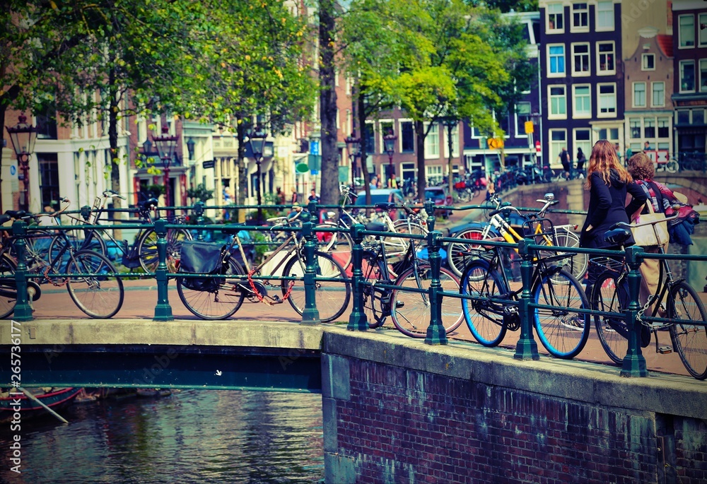 bicycles over to the bridge in Amsterdam with old toned effect