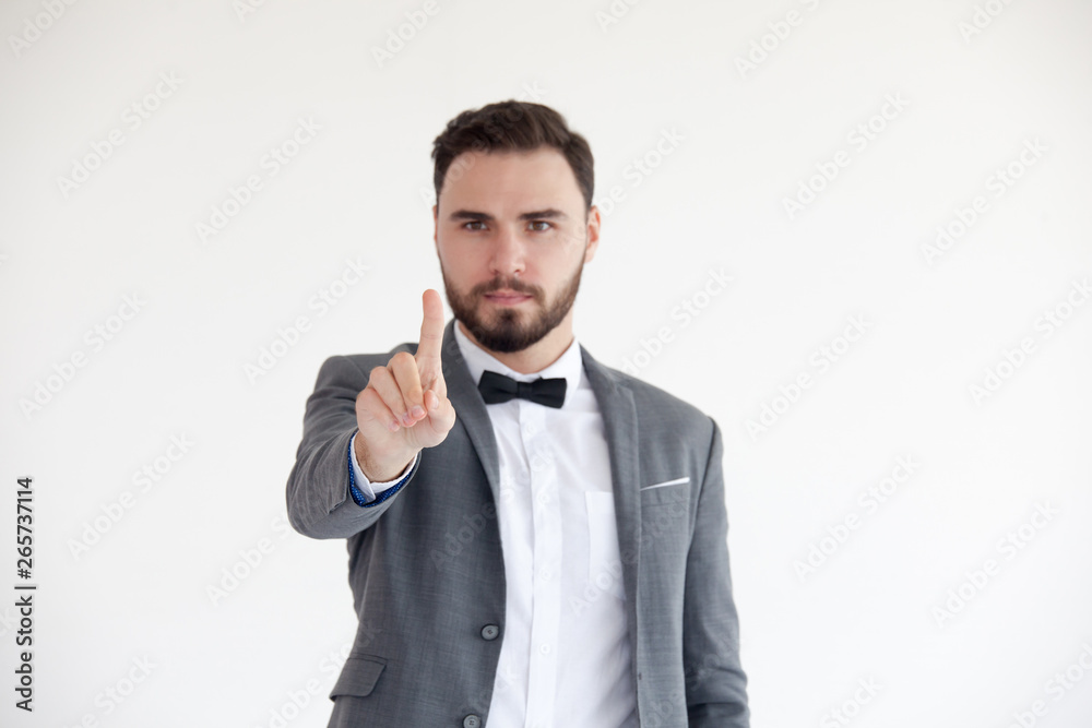Man is standing and shows outstretched hand with open palm. Businessman hand touching virtual screen Man is standing and shows outstretched hand with open palm. Businessman hand touching virtual screen