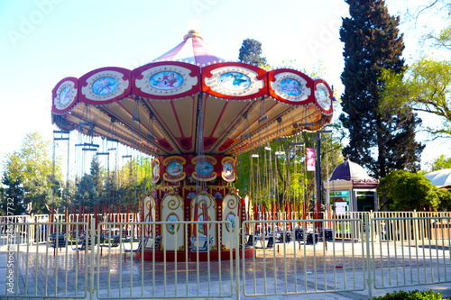Photography Children's bright carousel  in the center of the square close-up