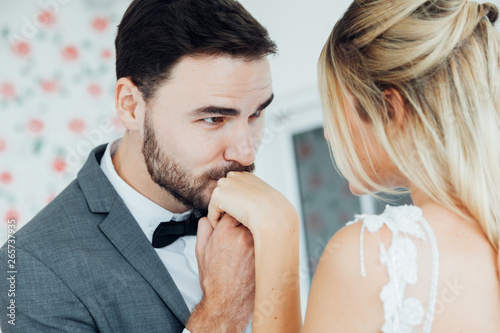 Bearded man kisses woman's hand. man kissing a woman's hand over white background. photo