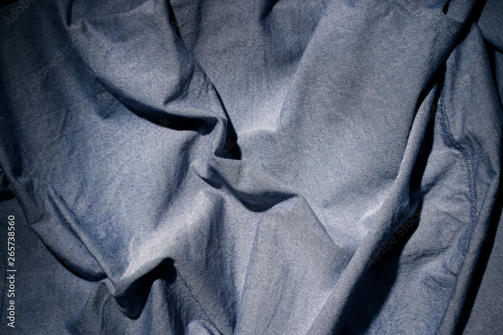 Fototapeta premium Dramatic lighting on denim fabric