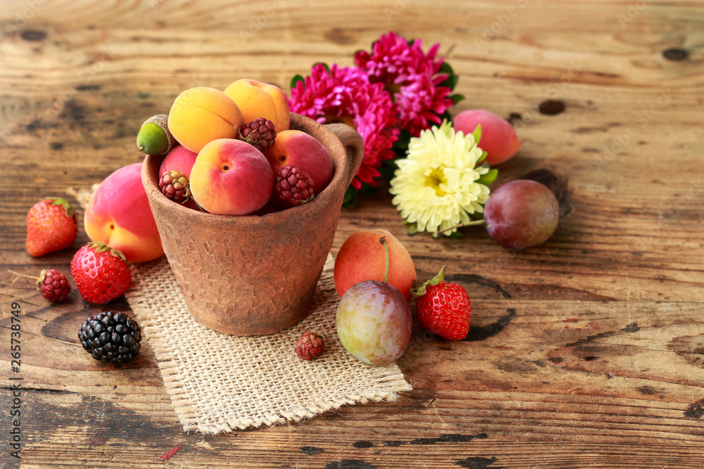 Ceramic bowl with various fruits. Wooden background. Ceramic bowl with various fruits. Wooden background.