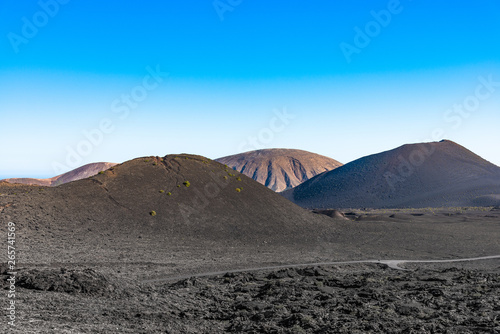 Timanfaya National Park  mountains of fire Lanzarote  Canary Islands  Spain. Unique panoramic view of spectacular lava river flows from a huge volcano crater creates a lunar landscape on planet earth.