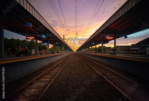 Tigaraksa KRL Commuter Line Train Station at Sunset with Two Line of Railroad or Railway.