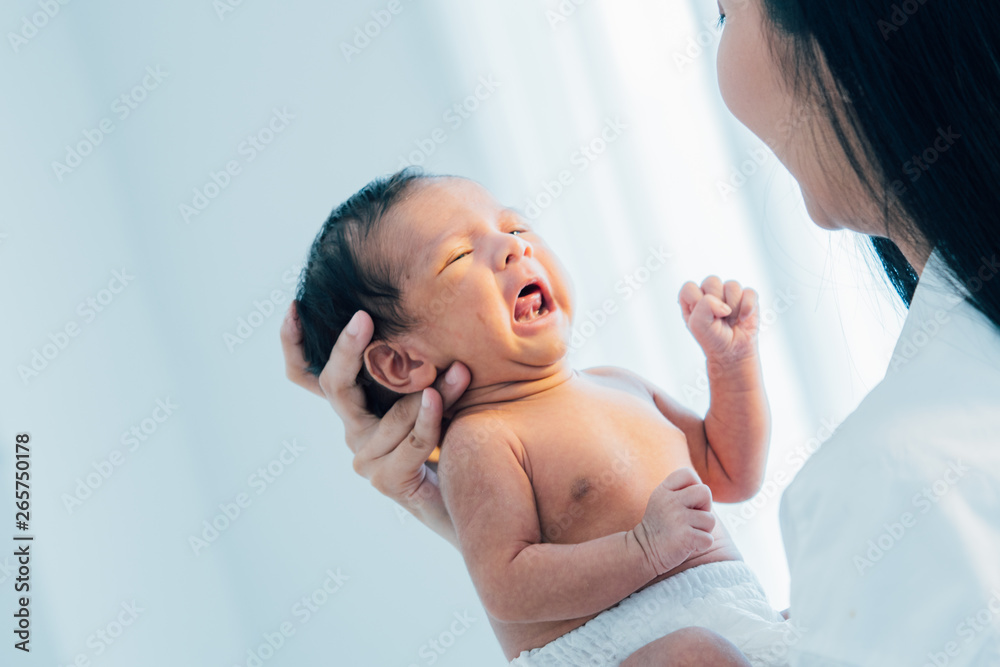Asian newborn baby with mother concept : young mother breast feeds newborn in living room Asian newborn baby with mother concept : young mother breast feeds newborn in living room