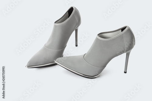 Grey transparent fabric high heel shoes over white background