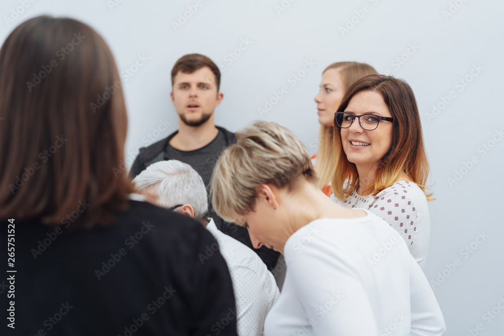 Smiling friendly businesswoman turning to look Smiling friendly businesswoman turning to look