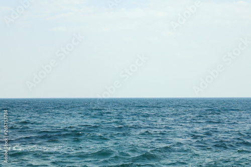 Blue sea water surface against sky. Space for text