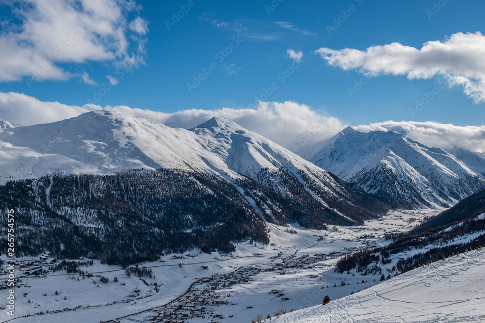 Winter view from the top on Livigno city and lake Livigno. Italy.