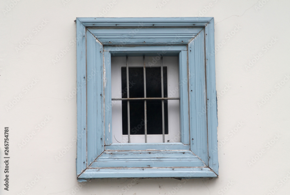 Wooden window with metal grill