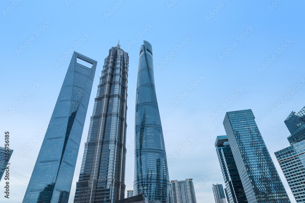 The pedestrian pavement under the tall building large building.