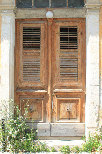 Vintage wooden front door in sunlight